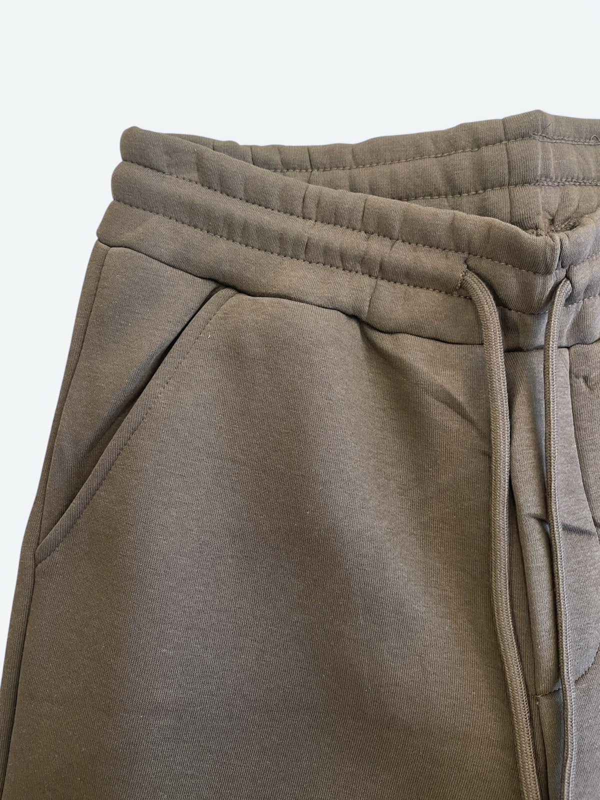 Dettaglio della vita elasticizzata, della coulisse e della tasca laterale del pantalone Issai AGM marrone