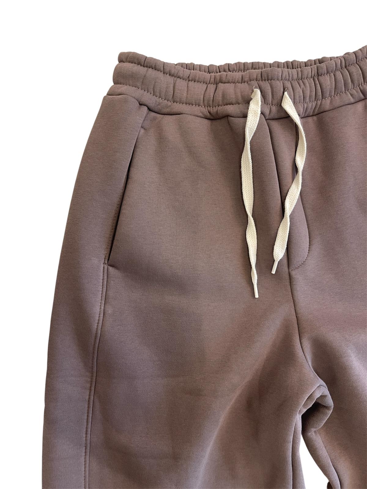 Dettaglio della vita elasticizzata, della coulisse chiara a contrasto e della tasca laterale del pantalone Yoshi AGM marrone