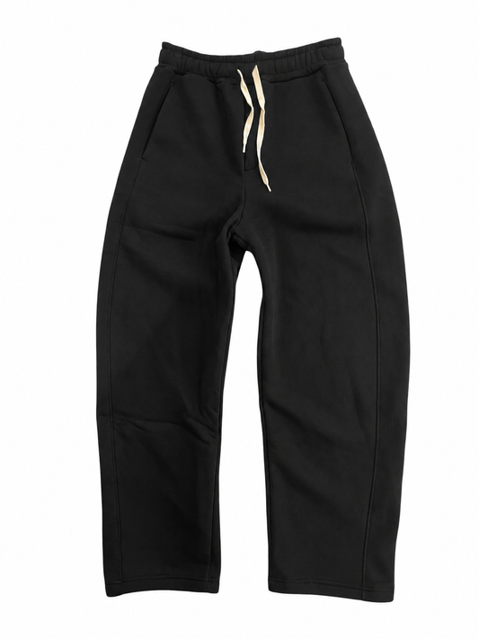 Pantalone Yoshi AGM in cotone felpato nero, vista intera frontale con gamba ampia, cuciture sagomate e coulisse chiara